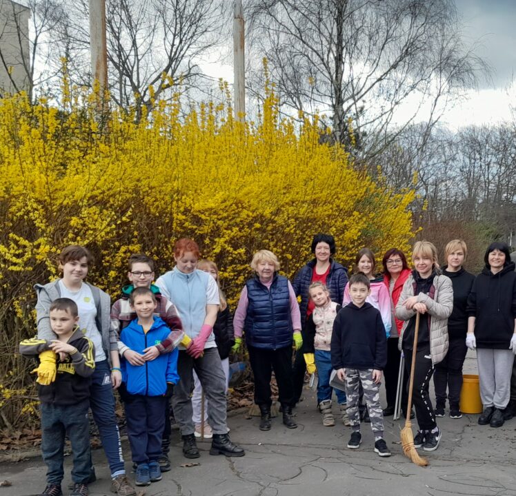 Families participate in a clean-up day for Ukrainian refugee hotel
